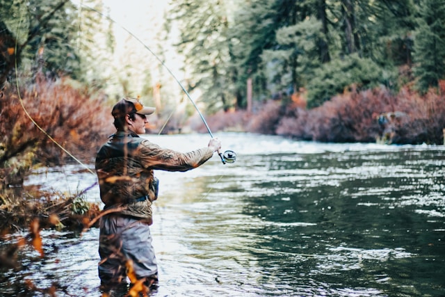A photo of a man fishing in a river.