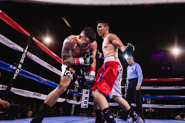 A photo of two boxers fighting in the ring.
