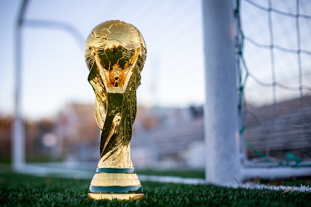 A photo of the World Cup trophy in front of a goal.